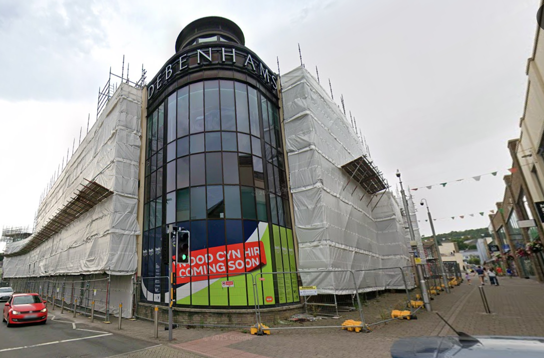 Street‑level view of the former Debenhams building in St Catherine’s Walk, Carmarthen, showing the large multi‑storey frontage.