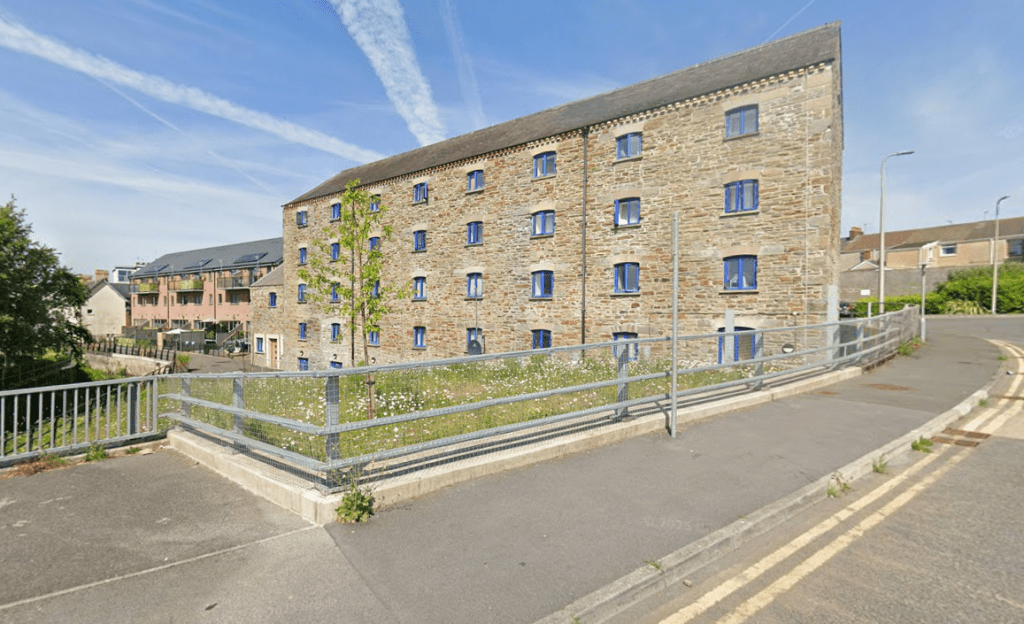 Restored frontage of the former Buckley’s Brewery in Llanelli, showing the converted maltings building overlooking the River Lliedi as part of the Pen y Porth housing development.
