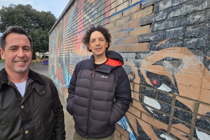 Cllr Andrew Stevens and Jeremy Donaldson standing on site at Victoria Park during the start of construction on the new skate plaza.