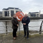 Councillor Andrew Stevens and Water Safety Co‑ordinator Andrew Suter standing beside the River Tawe discussing Swansea Council’s new water safety sensors. (Swansea Council)