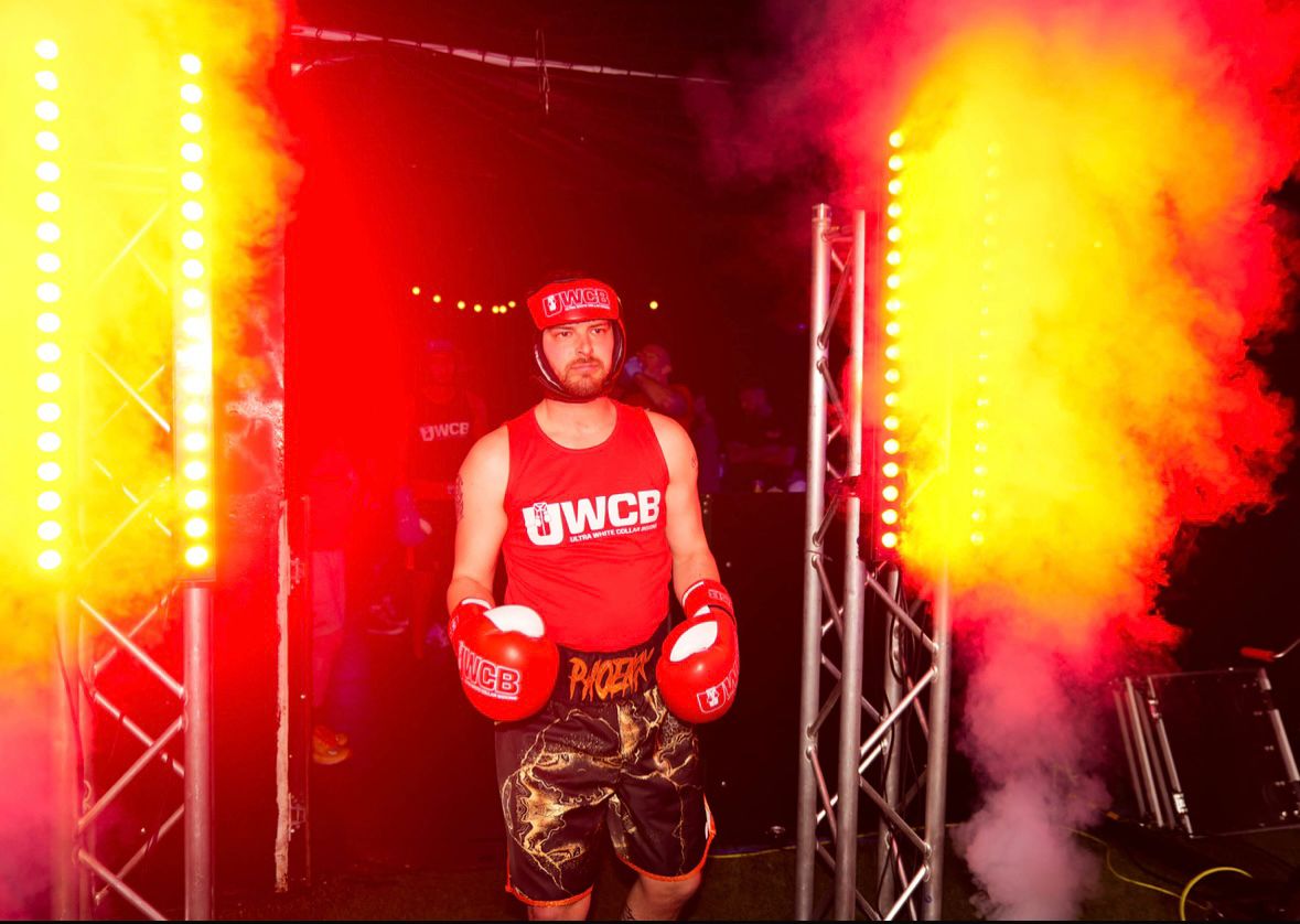 Anthony Trubridge walking into the boxing arena through a gateway of fire during his Ultra White Collar Boxing entrance.