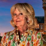 Portrait of Swansea contestant Fiona Hughes from The Traitors Series 4, smiling against a dark studio backdrop.