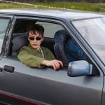 man wearing black sunglasses holding a gun