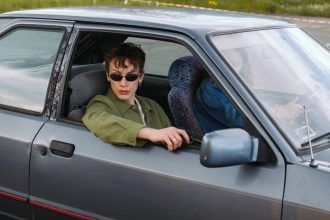 man wearing black sunglasses holding a gun