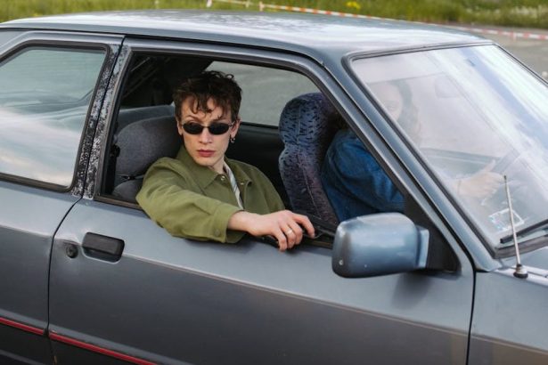 man wearing black sunglasses holding a gun