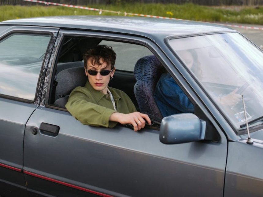 man wearing black sunglasses holding a gun