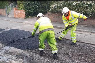 Highways workers laying fresh tarmac as part of Swansea Council’s winter road repair programme.