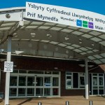Main entrance of Withybush General Hospital in Haverfordwest, showing the bilingual signage and canopy structure above the doors.