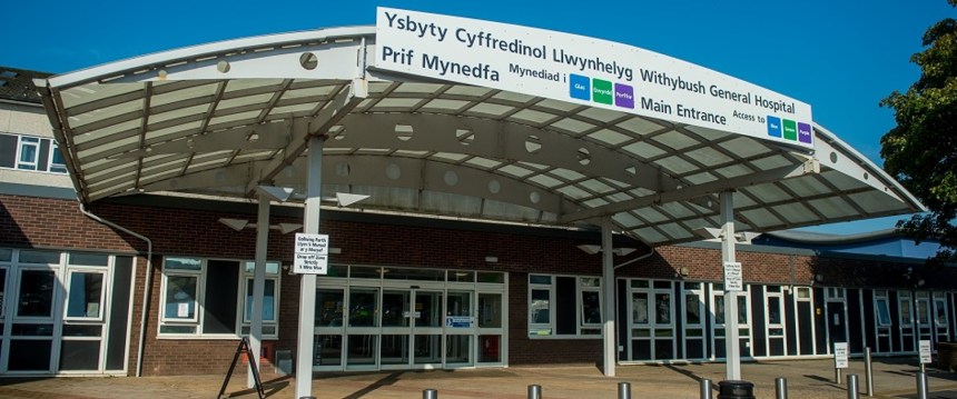 Main entrance of Withybush General Hospital in Haverfordwest, showing the bilingual signage and canopy structure above the doors.