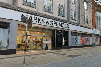 Marks and Spencer store frontage on Oxford Street in Swansea city centre showing the main entrance and display windows