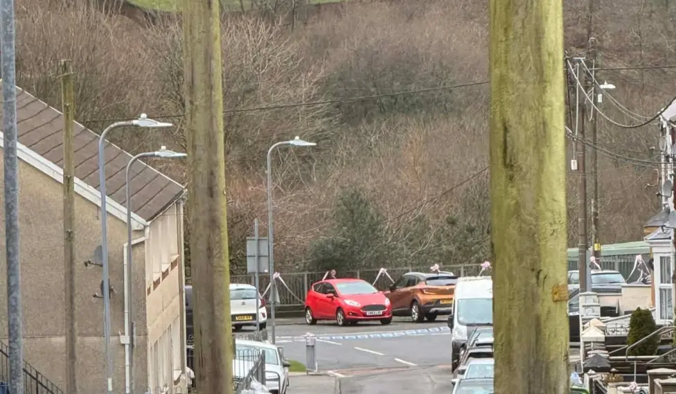 View of a closed road in Abergwynfi with parked cars and emergency restrictions in place.