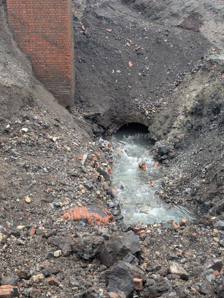 Excavated culvert and surrounding soil at the Cwmfelin sinkhole site.