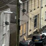 Bomb disposal robot positioned outside a property on Commercial Street during an ongoing police search.