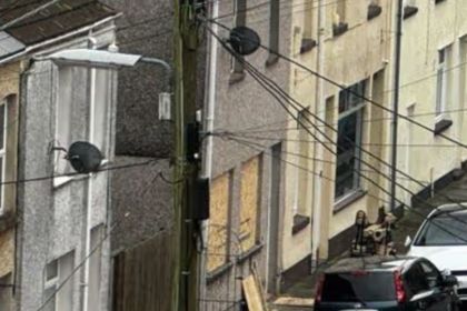 Bomb disposal robot positioned outside a property on Commercial Street during an ongoing police search.