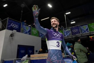 Marcus Wyatt waving in his Team GB kit at the Milano Cortina 2026 Winter Olympics.