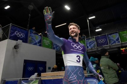 Marcus Wyatt waving in his Team GB kit at the Milano Cortina 2026 Winter Olympics.