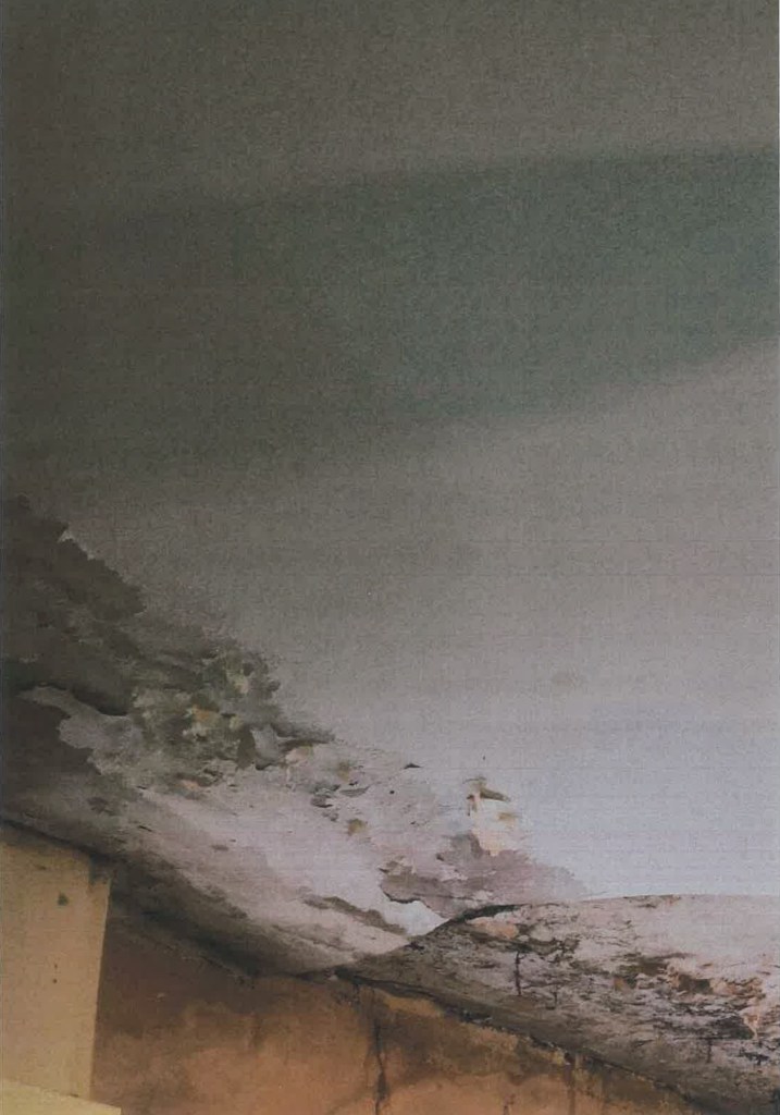 Severely damaged ceiling with peeling plaster and water staining, photographed during Cardiff Council’s investigation into rogue builder Lee Slocombe.