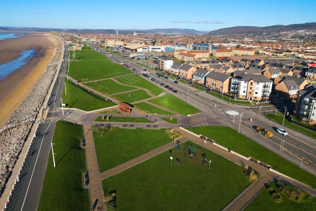 Aerial photograph of Aberavon seafront showing the promenade, beach, green spaces and nearby housing.