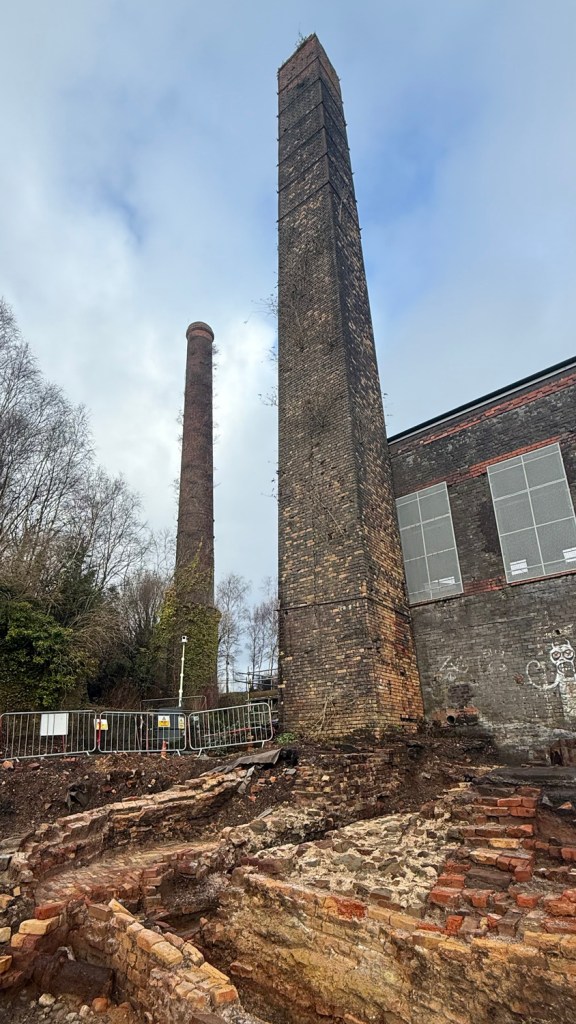 Historic chimneys of the Musgrave and Vivian Engine Houses with excavated flue visible at the Hafod-Morfa Copperworks site