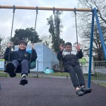 Children on swings at Coed Gwilym Park Clydach Swansea upgraded play area Welsh Government funding