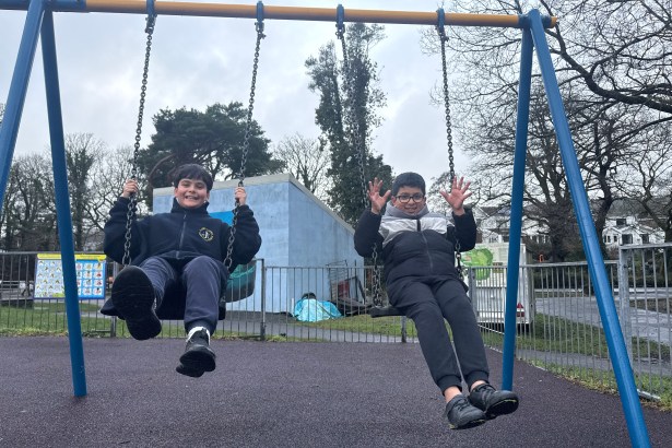 Children on swings at Coed Gwilym Park Clydach Swansea upgraded play area Welsh Government funding