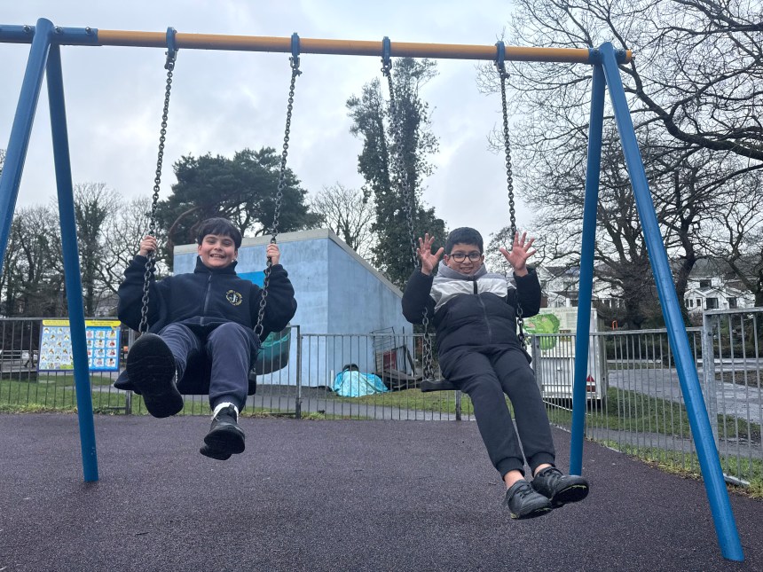 Children on swings at Coed Gwilym Park Clydach Swansea upgraded play area Welsh Government funding