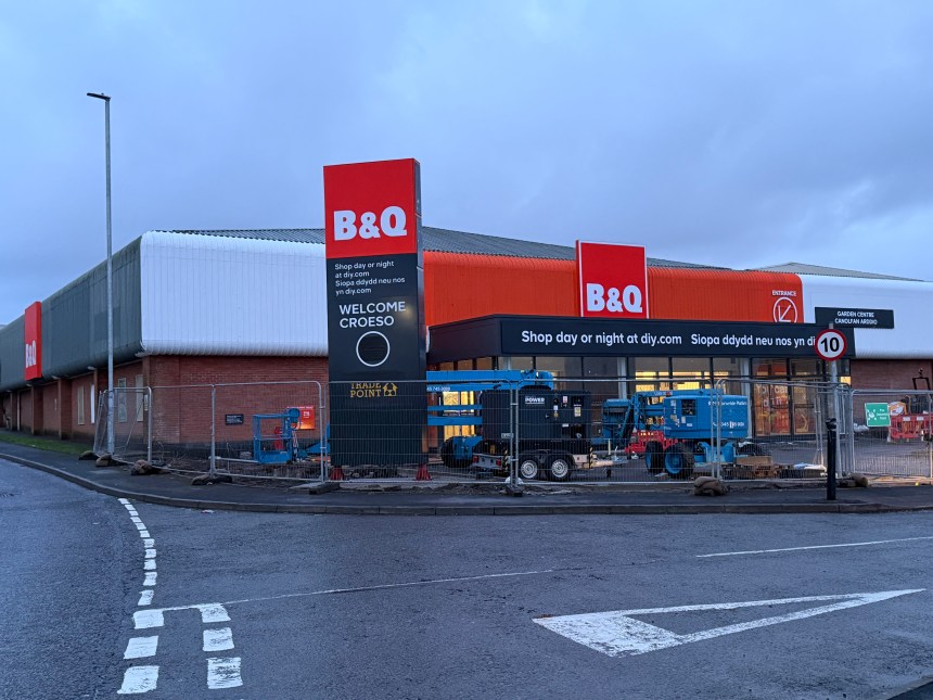Exterior of the new B&Q Carmarthen store with construction fencing and equipment in front of the entrance.
