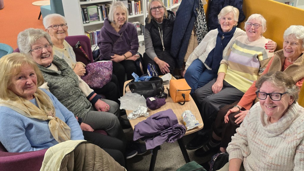 Group members from Mentro Allan seated together inside Y Storfa’s community space.