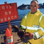 RSPCA Inspector Neil Tysall standing on the shoreline in Tenby during the Sea Empress response operation.