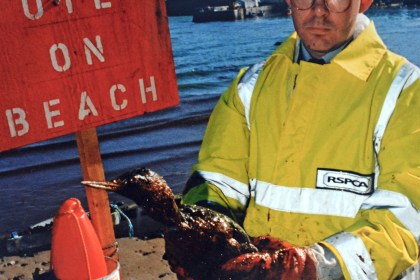 RSPCA Inspector Neil Tysall standing on the shoreline in Tenby during the Sea Empress response operation.