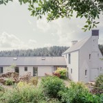 Pantybara’s main house set against woodland, showing modern rural architecture.