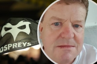 Ospreys team flag with a stylised white mask logo, overlaid with a circular portrait of supporter Rob Thomas.