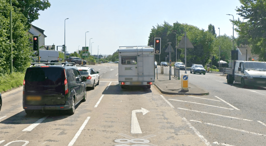 Image of the A4138 Halfway junction in Llanelli, showing vehicles at a red light, a pedestrian island, and road markings for turning lanes.