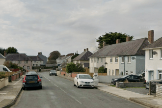 Residential street view of Hawkstone Road in Pembroke Dock with parked cars and semi‑detached houses.