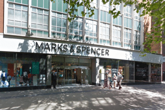 Marks & Spencer storefront on Oxford Street in Swansea city centre showing the store entrance with M&S Cafe visible on the right side