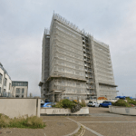 Aurora apartment building in Swansea Marina covered in scaffolding during remediation work