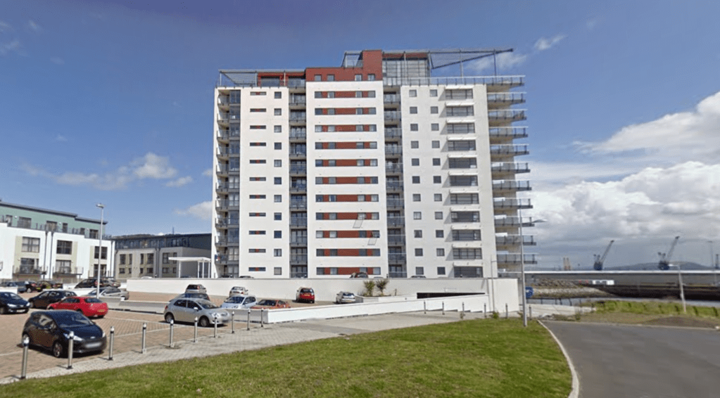 Aurora apartment building in Swansea Marina in 2011 showing pristine facade with colored balconies"