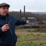 Cllr Joe Hale pointing at Kilvey Hill during video announcement