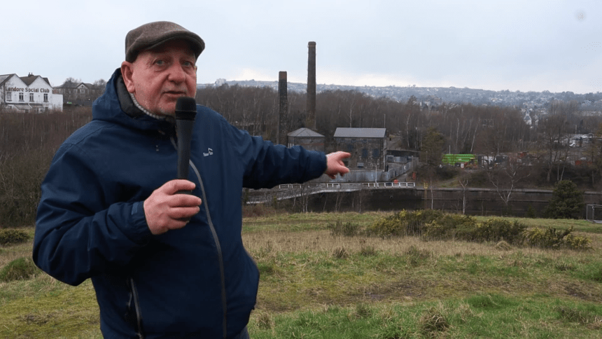 Cllr Joe Hale pointing at Kilvey Hill during video announcement