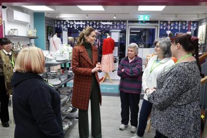 The Princess of Wales speaking with staff and volunteers inside the Tŷ Hafan charity shop in Lampeter.