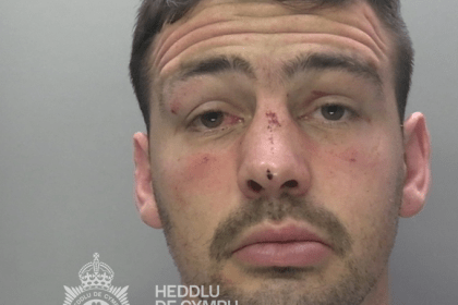 A police custody photograph of Nathan Bantick, showing facial injuries, against a plain background with a South Wales Police watermark.