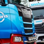 Owens Group lorries parked at a depot, representing the impact of rising diesel prices on the Welsh haulage industry.