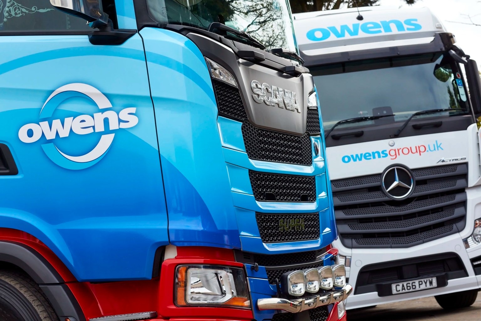 Owens Group lorries parked at a depot, representing the impact of rising diesel prices on the Welsh haulage industry.