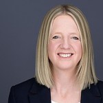 Portrait headshot image of WRU Chief Executive Officer, Abi Tierney on a dark background.