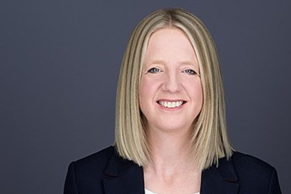 Portrait headshot image of WRU Chief Executive Officer, Abi Tierney on a dark background.