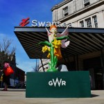 A colourful faery statue displayed outside Swansea railway station, inspired by Welsh folklore from Pennard Castle in the Gower.