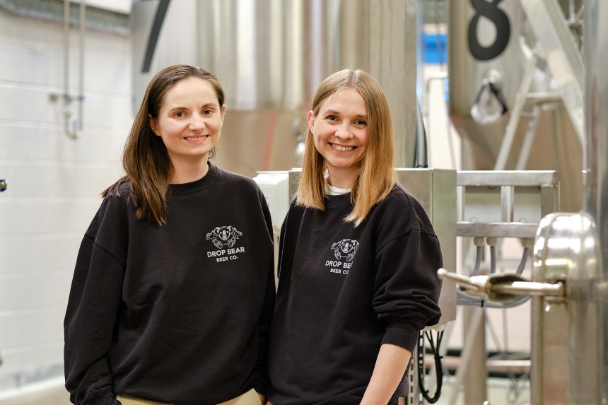 Joelle and Sarah Drummond, founders of Swansea-based Drop Bear Beer Co., standing together in a brewery setting.