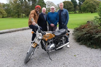 Fuzz Townshend, Sir Alan Bates, Ian and Tim Shaw pose with restored Triumph Bonneville after emotional rebuild reveal