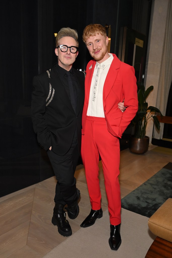 Steps singer Ian 'H' Watkins and broadcaster Owain Wyn Evans smile for the camera at a party.