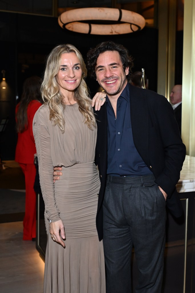 Singer Jack Savoretti and his wife, actress Jemma Powell, pose for a photo at an event.